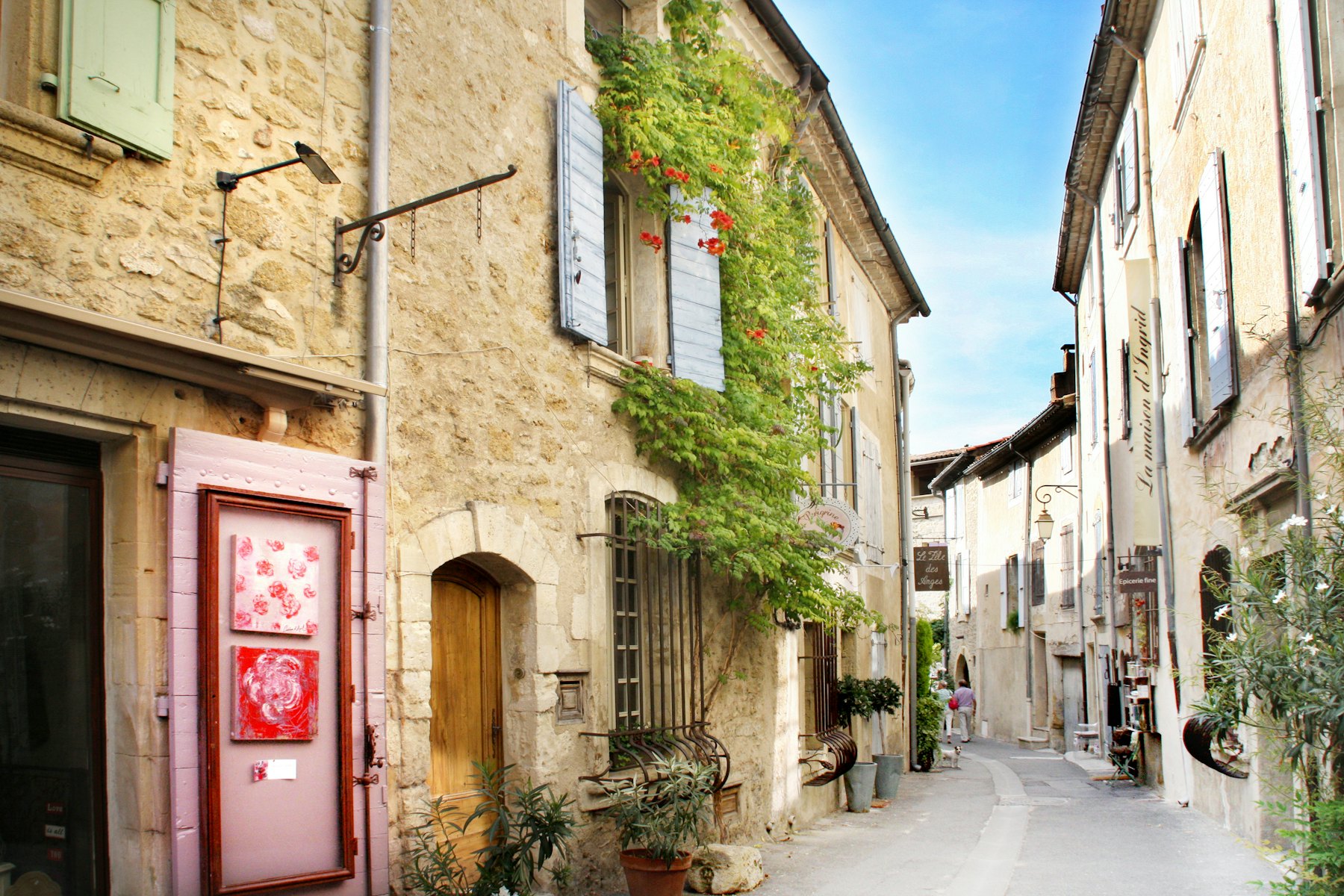 Village street lined with stone houses and greenery