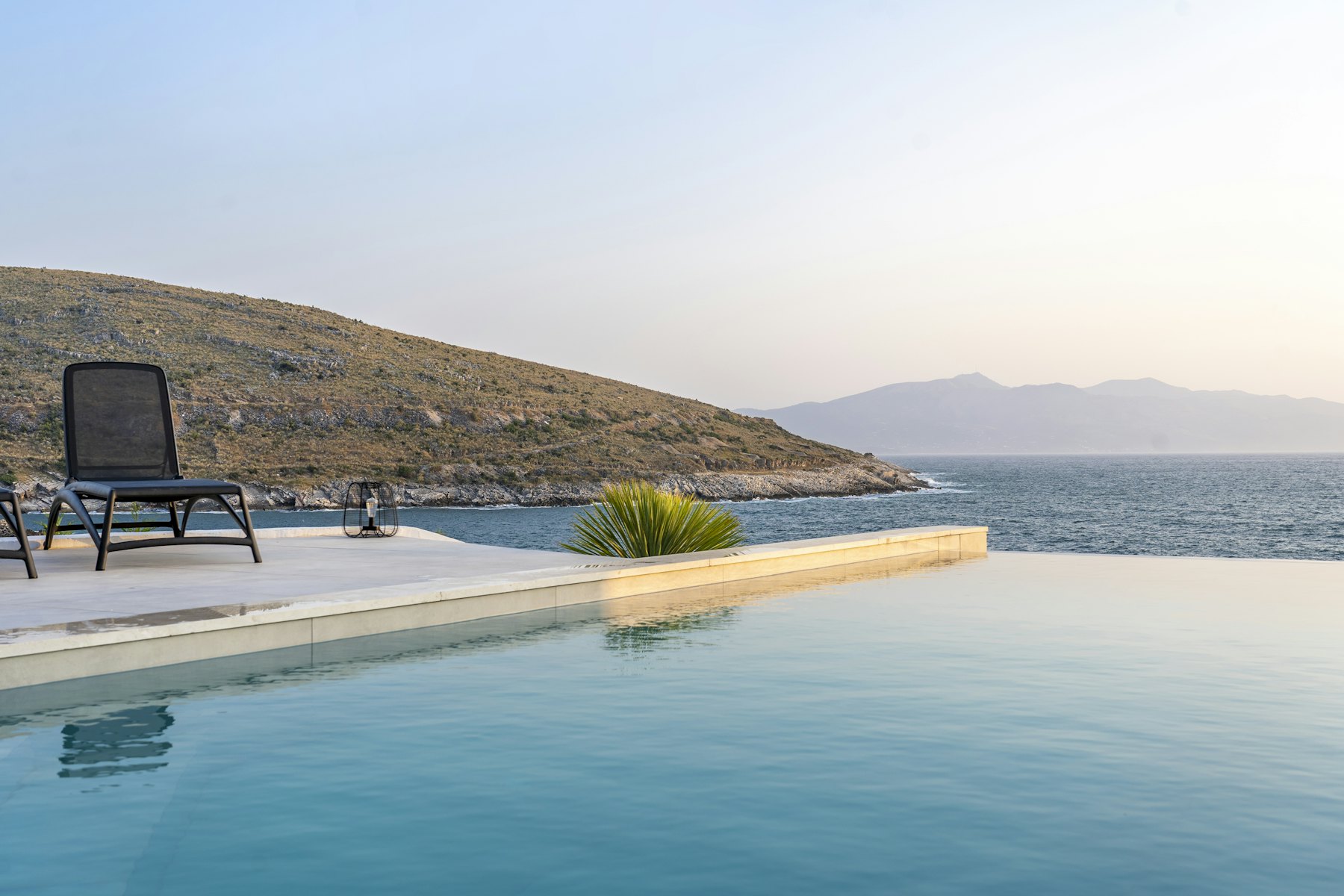 Infinity pool facing the sea at the end of the day