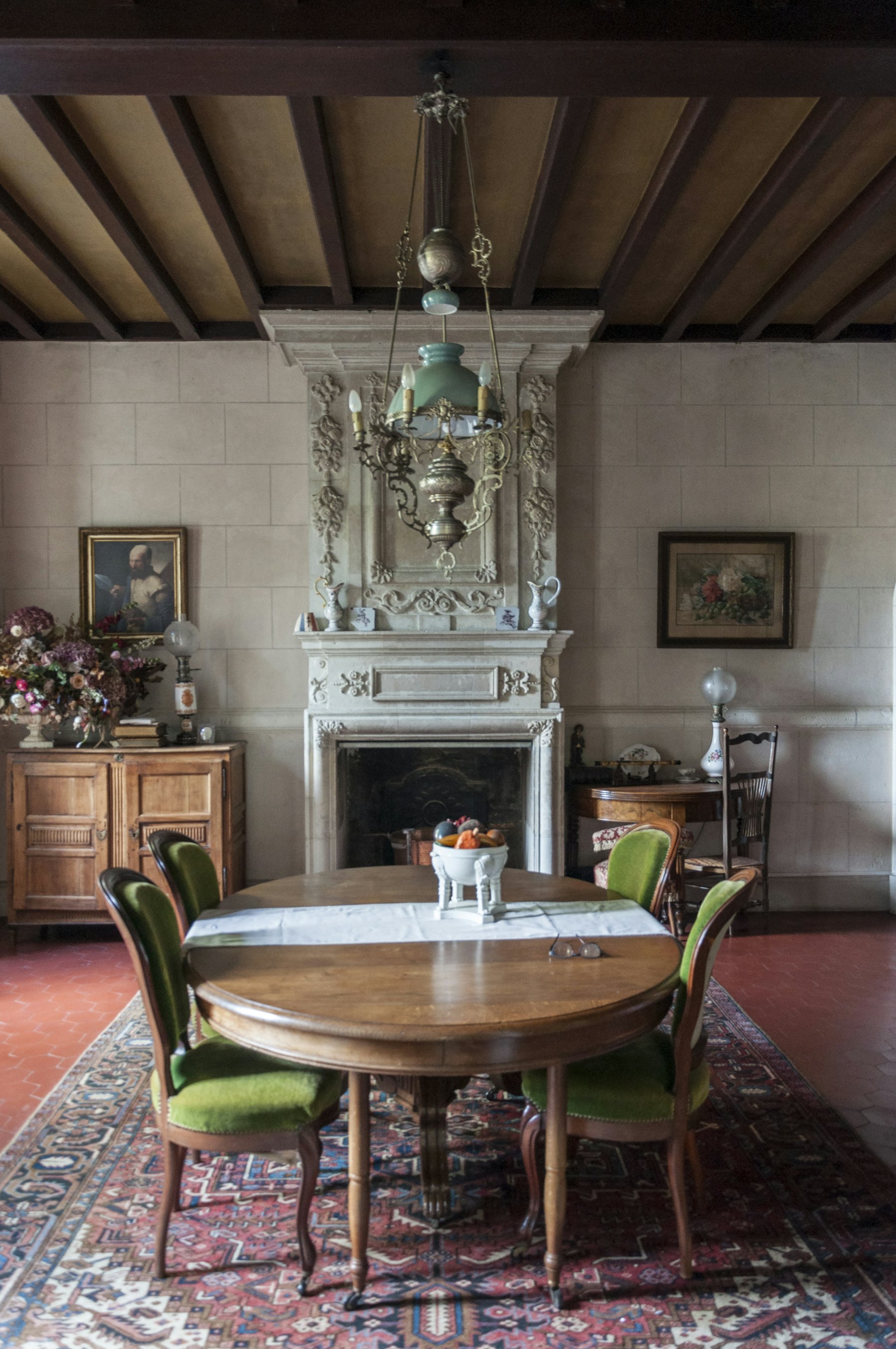 Old dining room with a carved stone fireplace